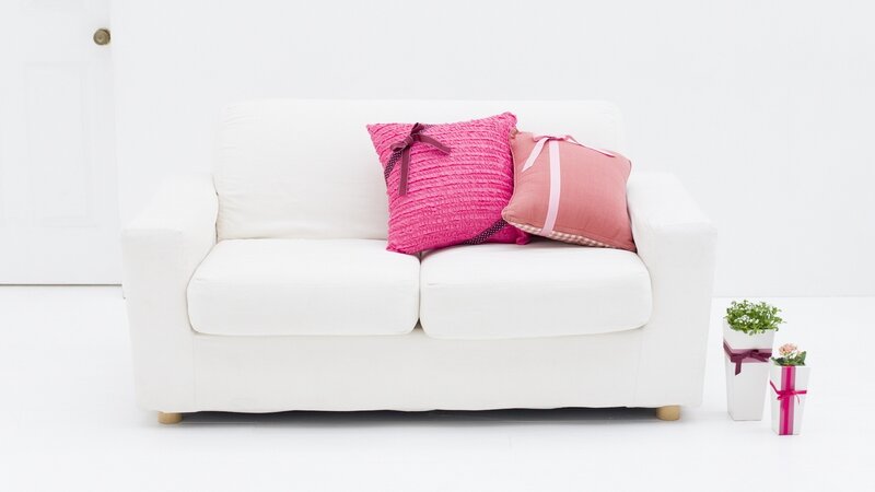 White sofa with pink pillows