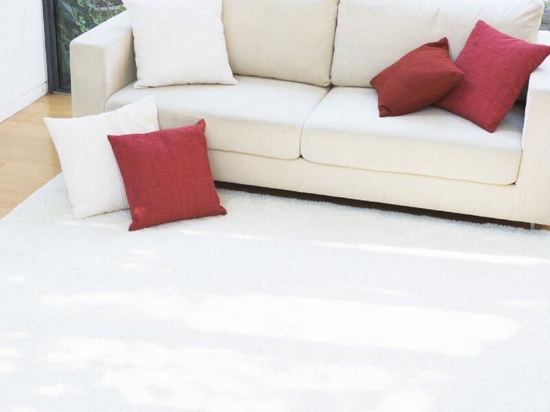 White sofa with red and white pillows