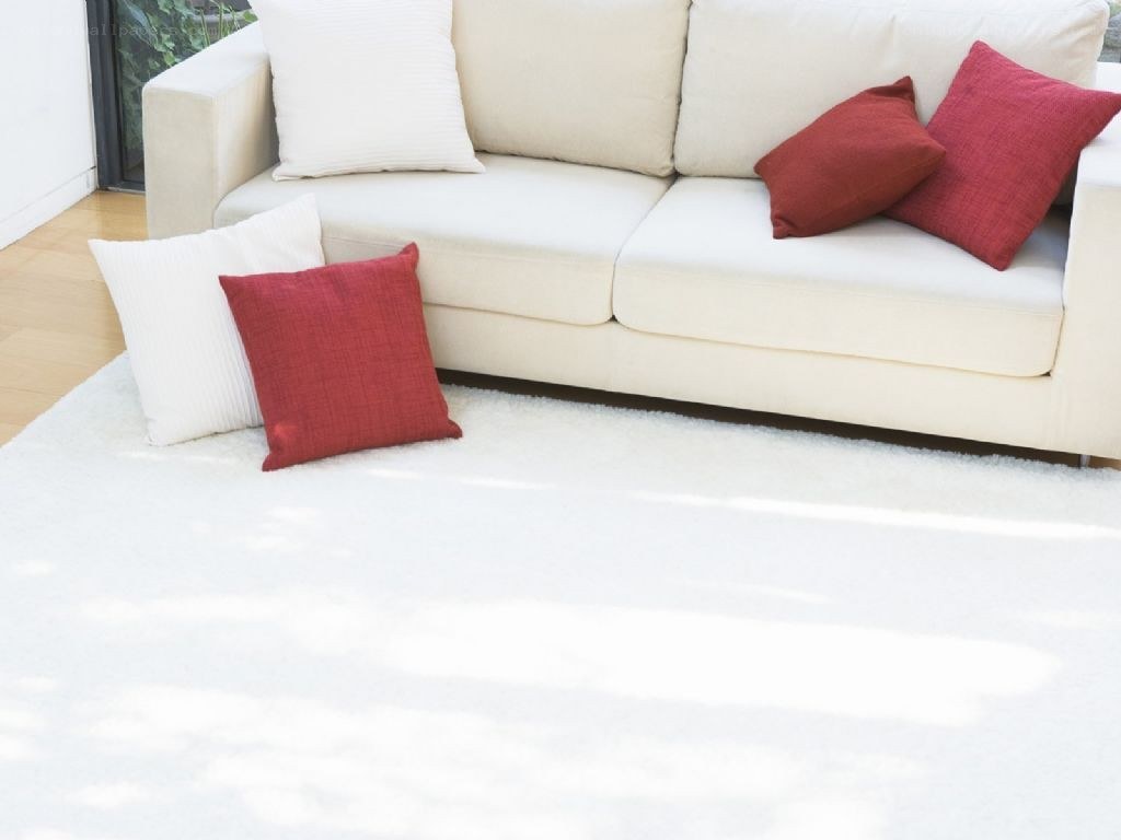 White sofa with red and white pillows