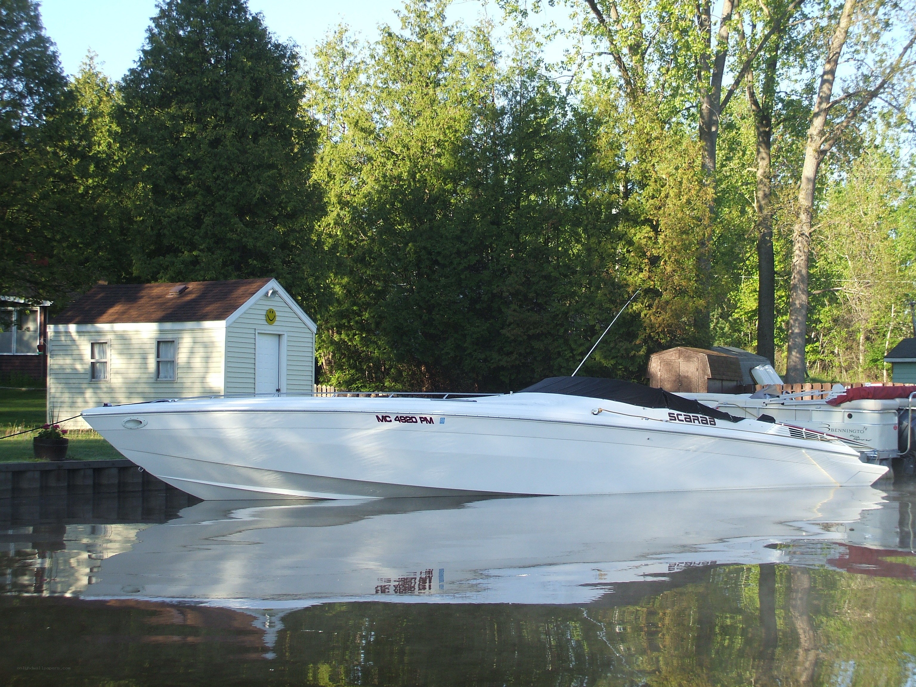 White speedboat at a dock