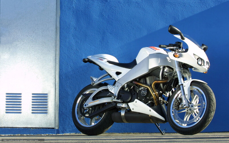 white sport motorcycle against blue wall
