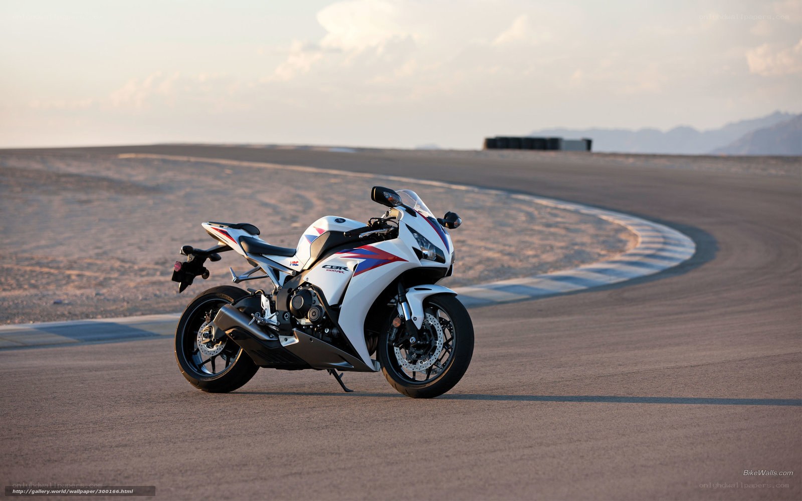 white sport motorcycle on track