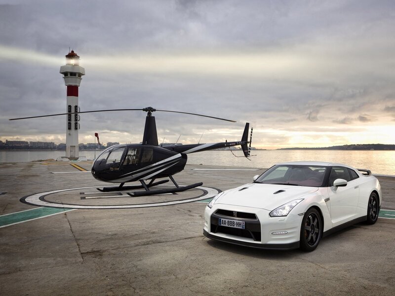 White sports car and helicopter at dock