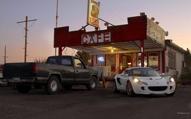 White sports car at a roadside cafe