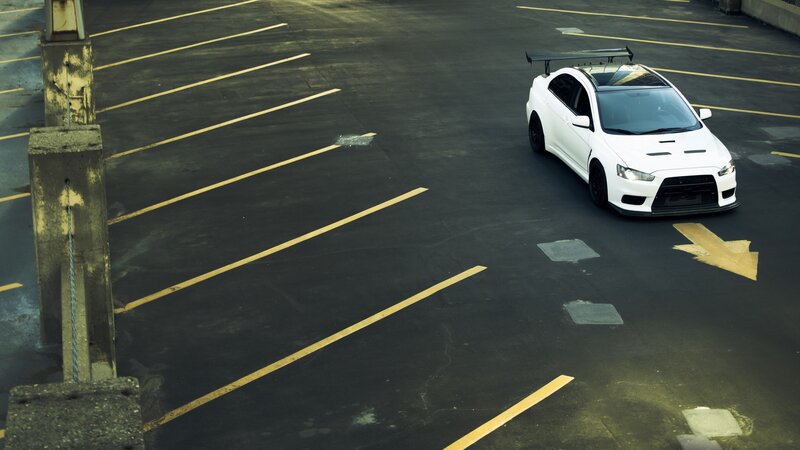 White Sports Car — Black, Dramatic, Photograph, Parking Lot, Arrow