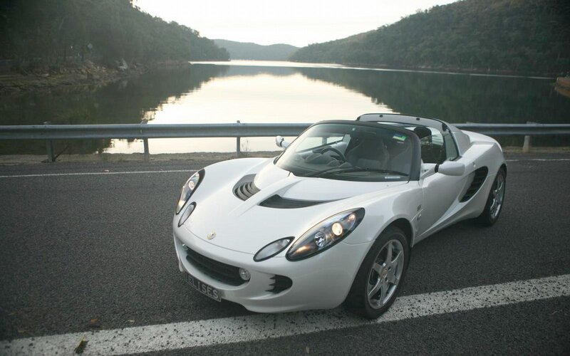 White sports car by the lake