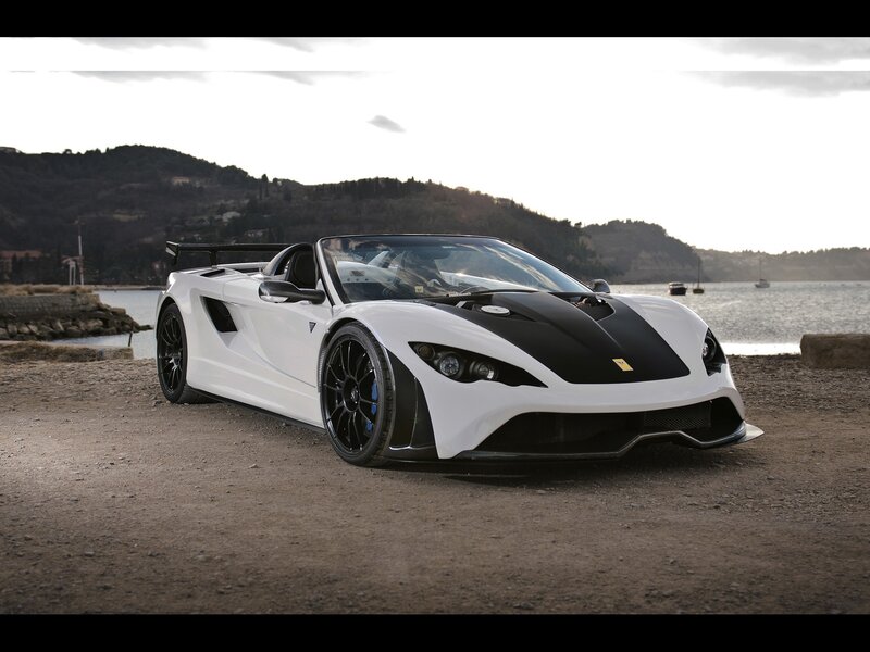 white sports car by the water