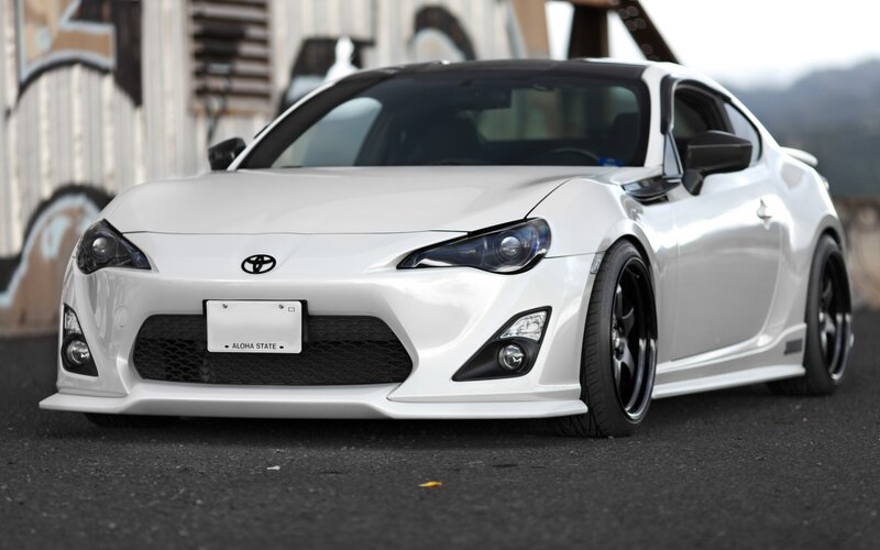 White Sports Car — Calm, Photograph, Graffiti Wall, Black Wheels