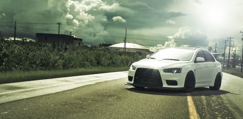 White Sports Car — Dramatic, Afternoon, Photograph, Road, Clouds, Buildings, Green