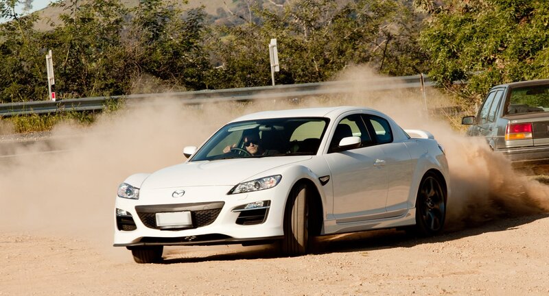 White sports car drifting on dirt