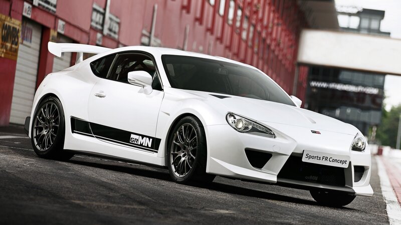 White Sports Car — Dynamic, Afternoon, Photograph, Race Track, Building
