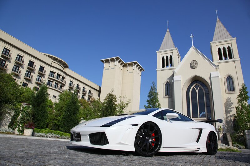 White sports car in front of church