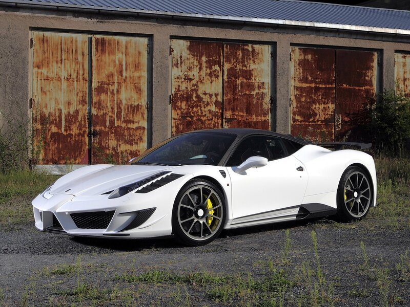 White sports car in front of garage