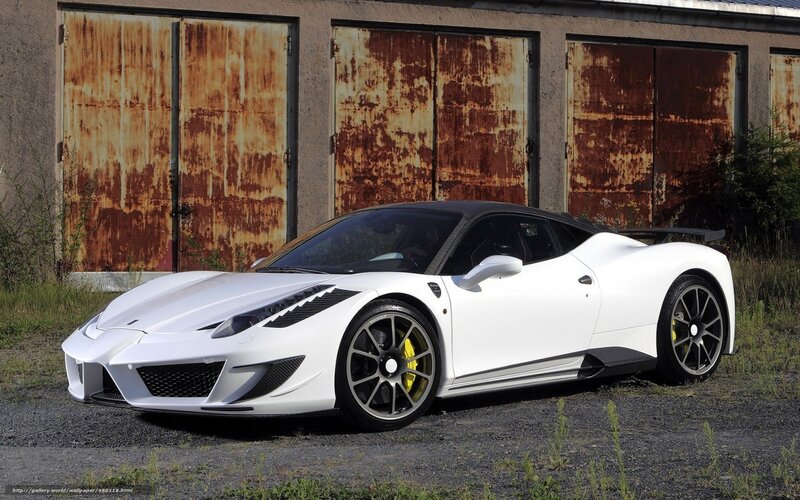 white sports car in front of garage