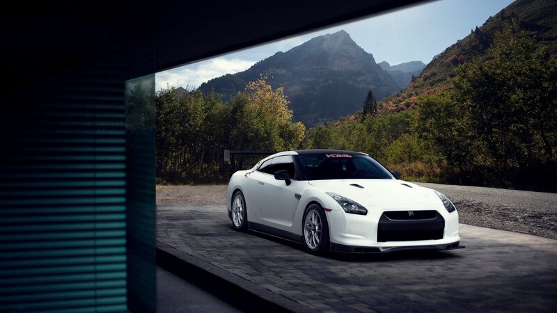 White sports car in mountain setting