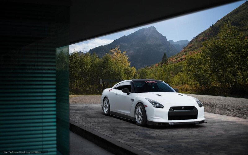 White sports car in mountain setting