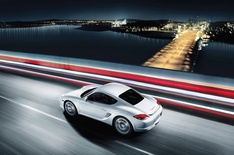 White sports car on a bridge at night