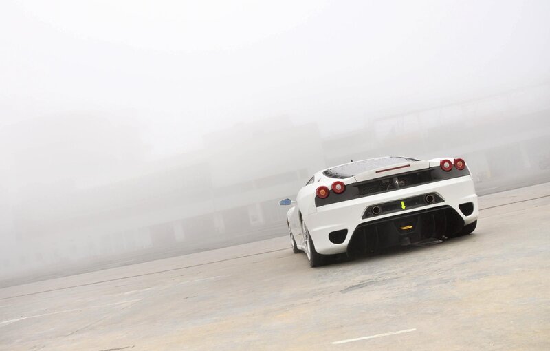 White sports car on a foggy track
