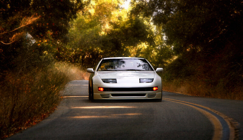 White sports car on a forest road