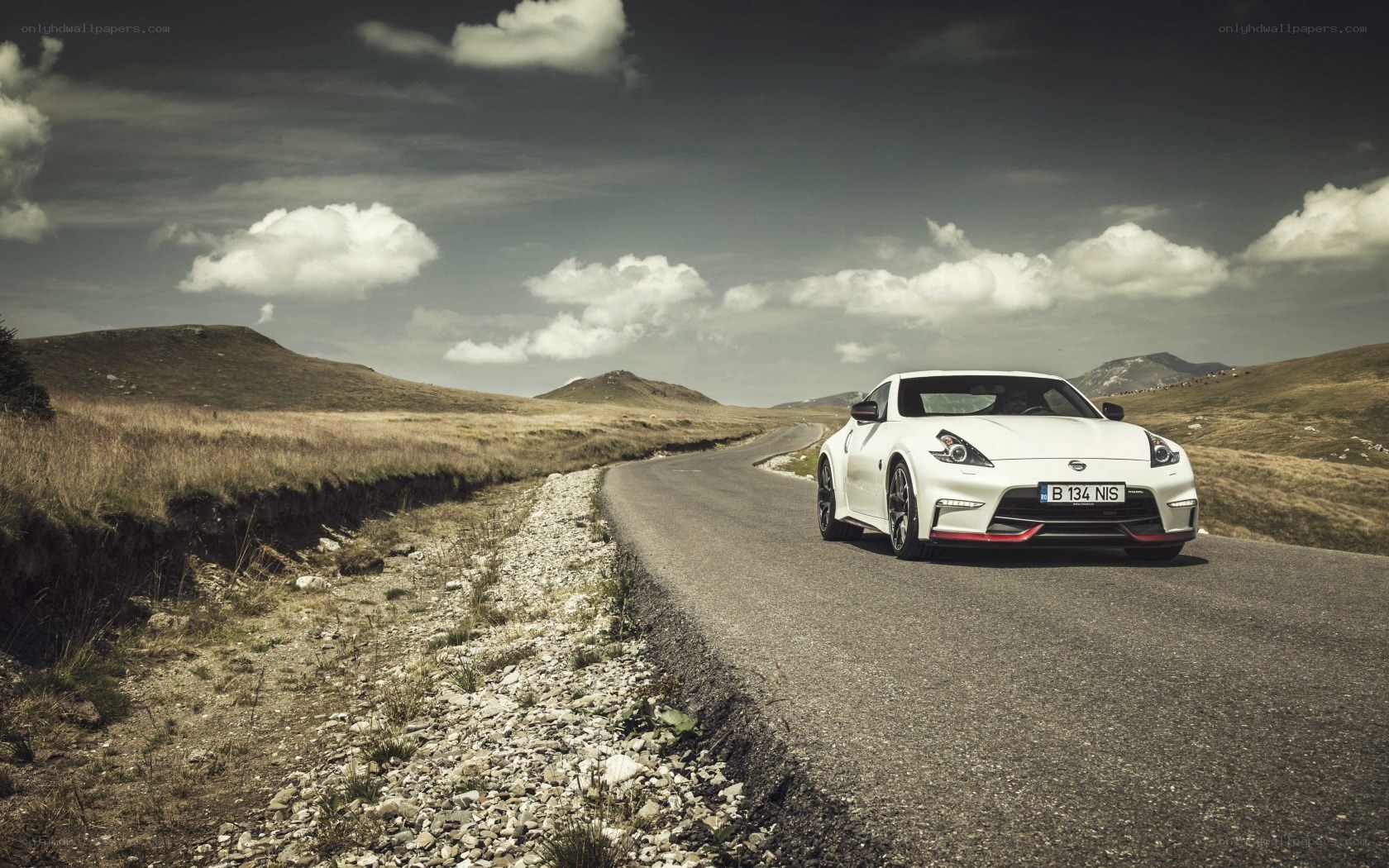White sports car on a winding road