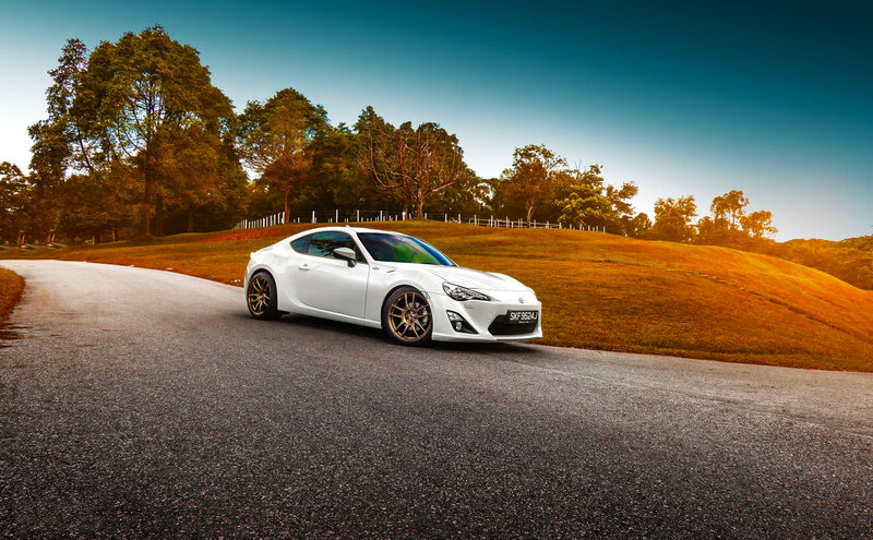 White sports car on a winding road