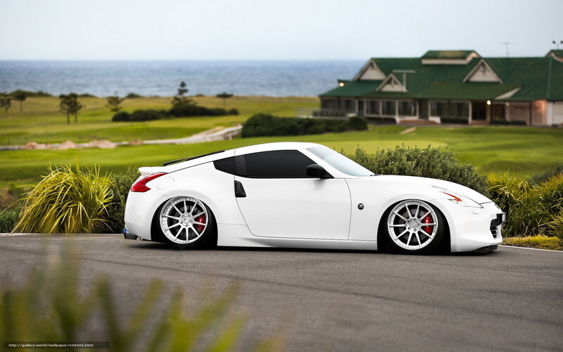 White sports car on coastal road