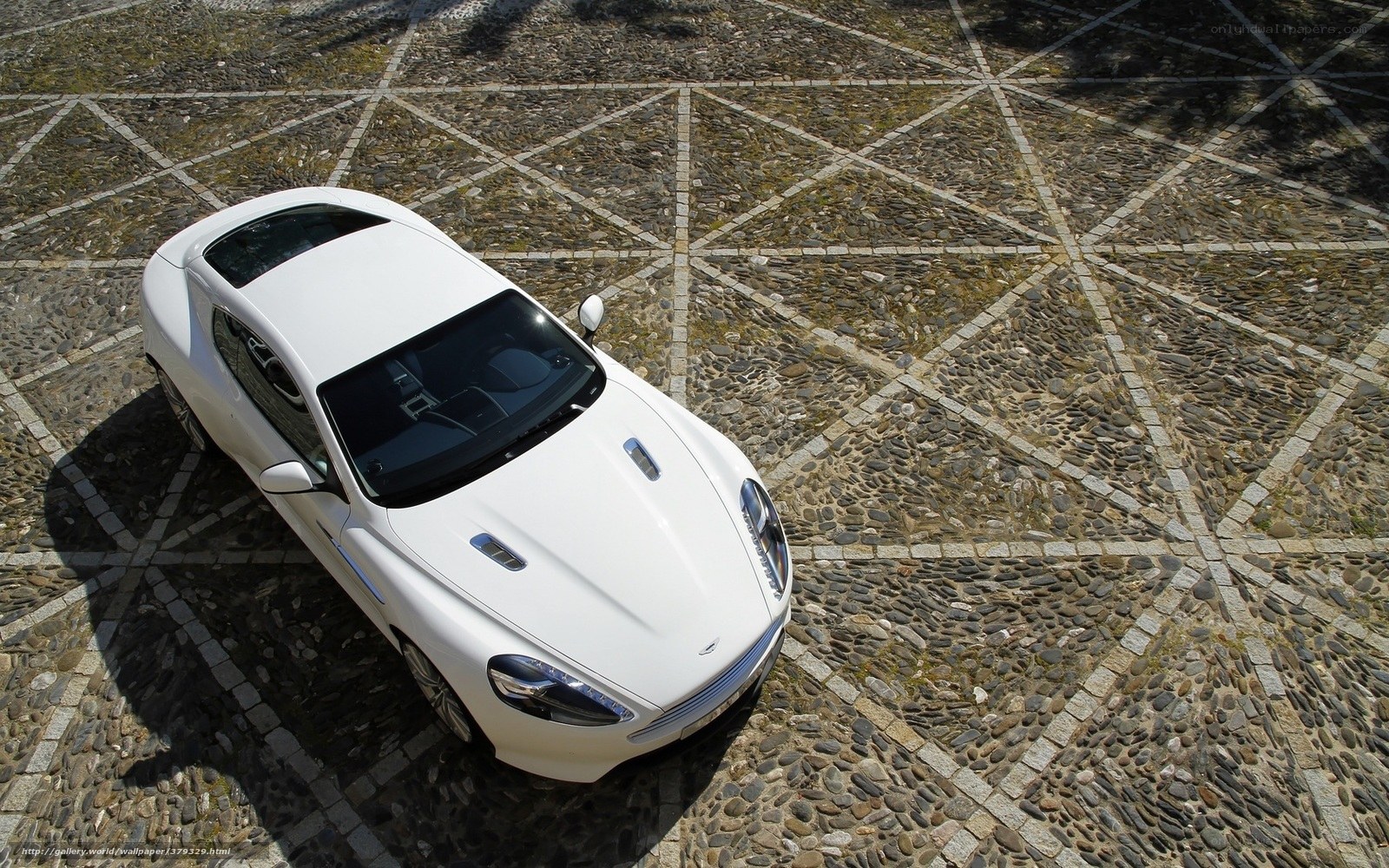 White sports car on cobblestone