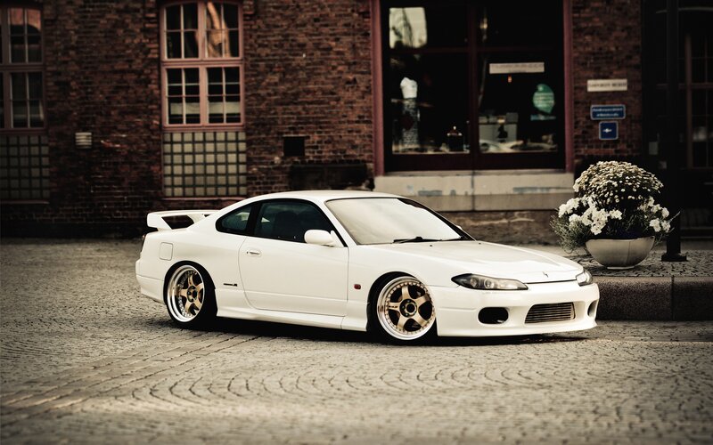 white sports car on cobblestones
