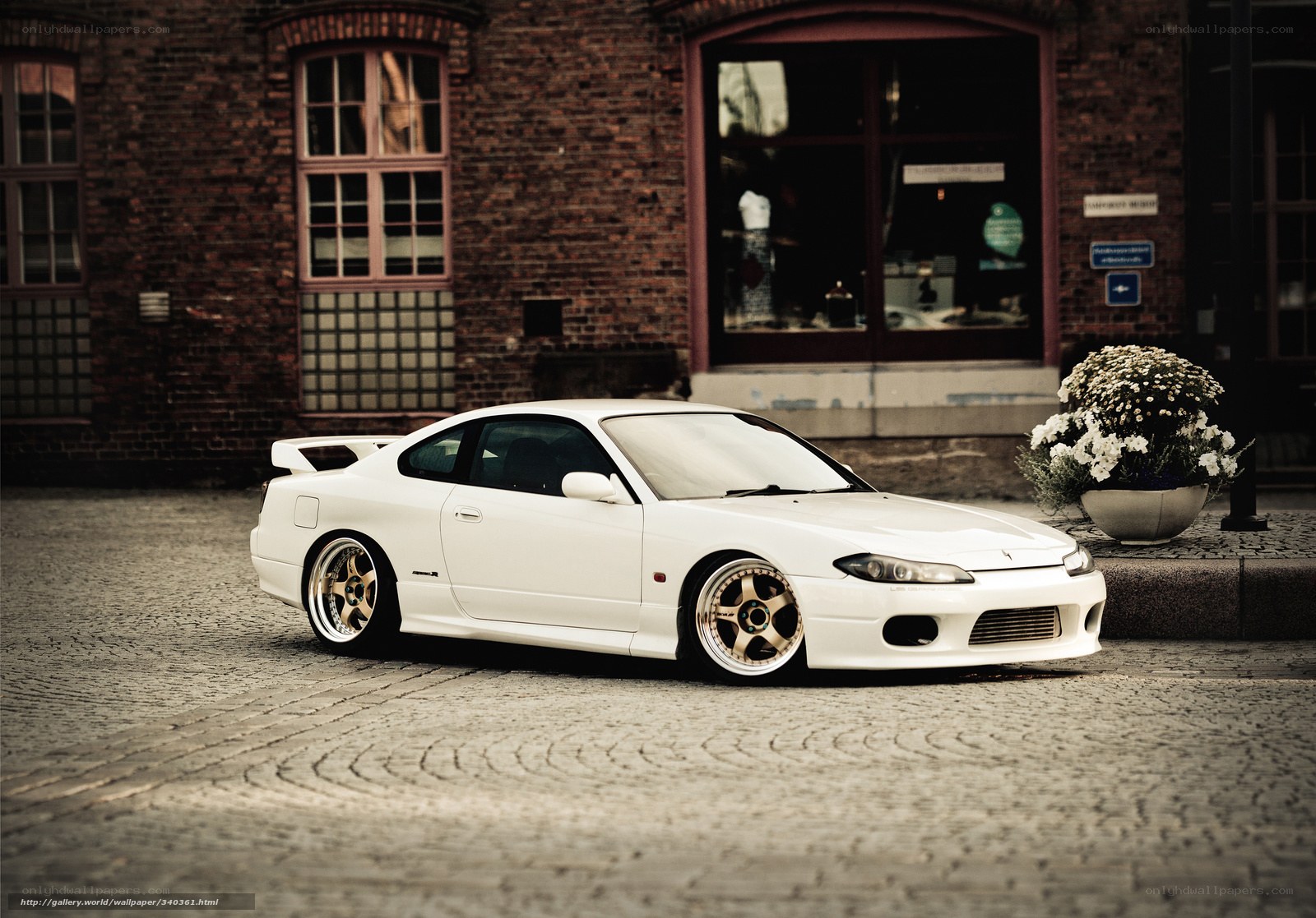 white sports car on cobblestones