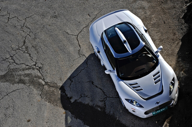 White sports car on cracked pavement