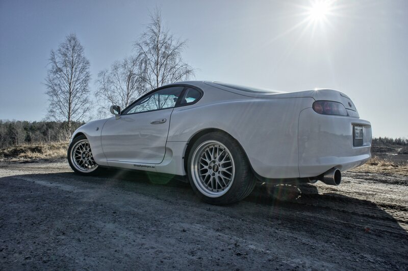 white sports car on dirt road