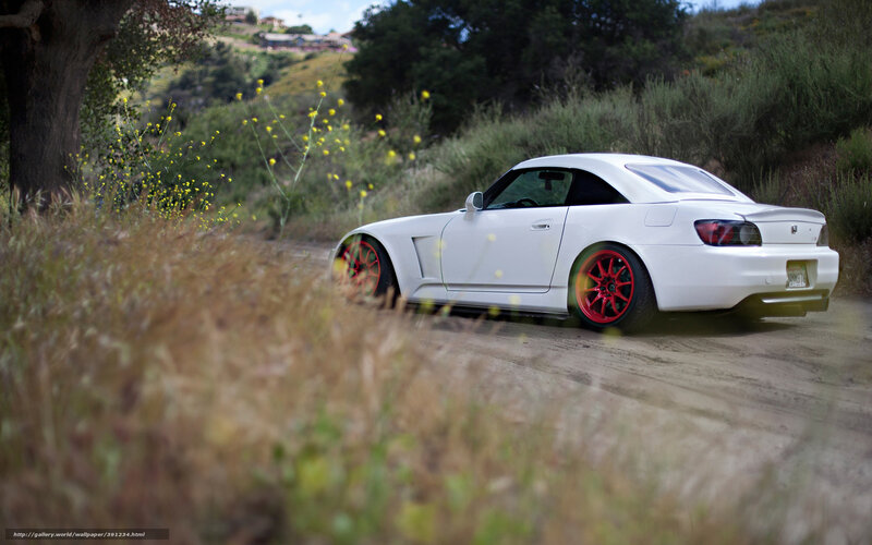 White sports car on dirt road