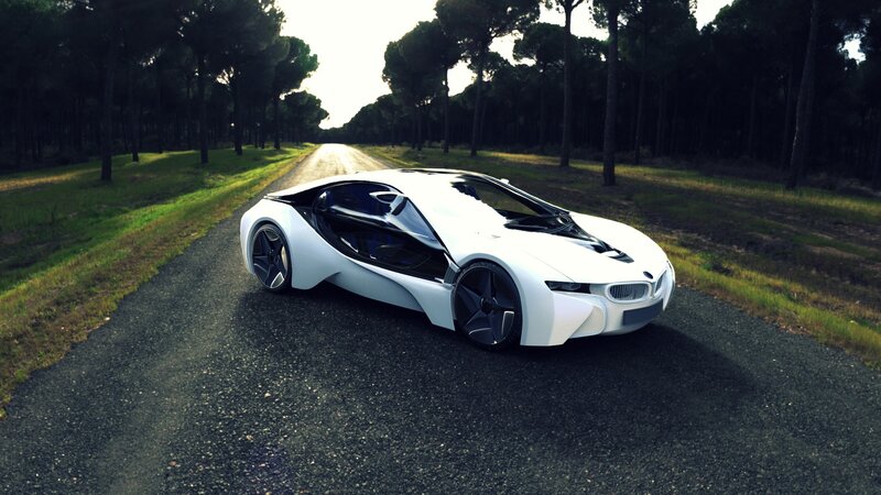 White sports car on forest road