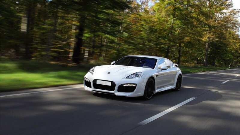 white sports car on forest road