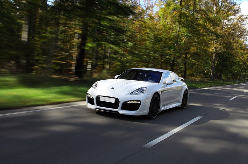 white sports car on forest road