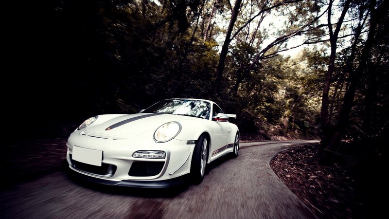 white sports car on forest road