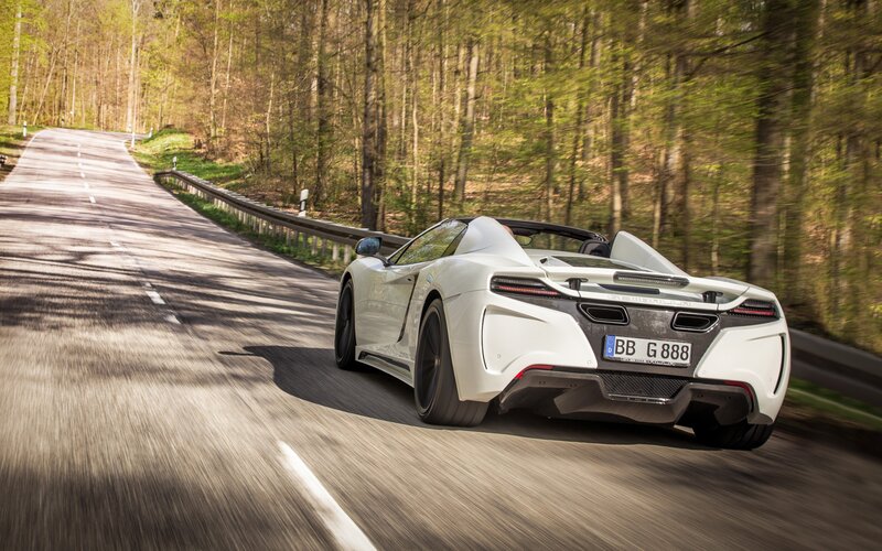 White sports car on forest road