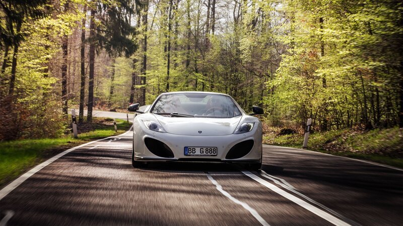 White sports car on forest road