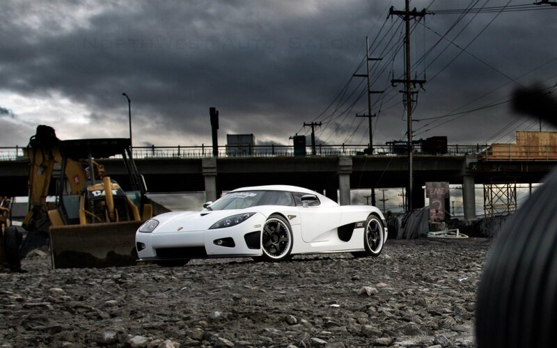 White sports car on gravel lot