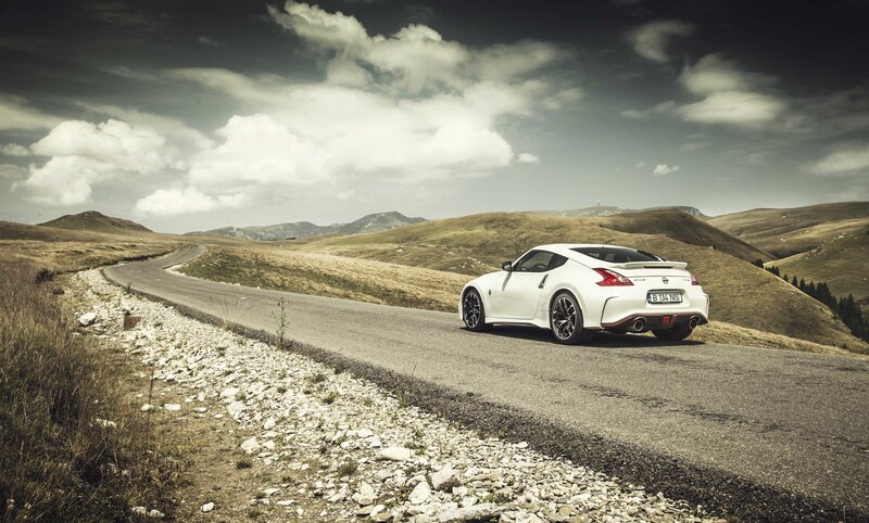 White sports car on mountain road