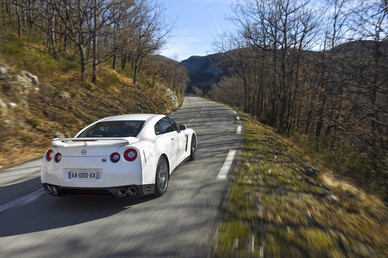 White sports car on mountain road