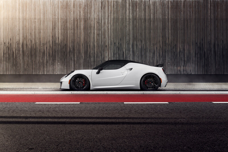 White sports car on red road