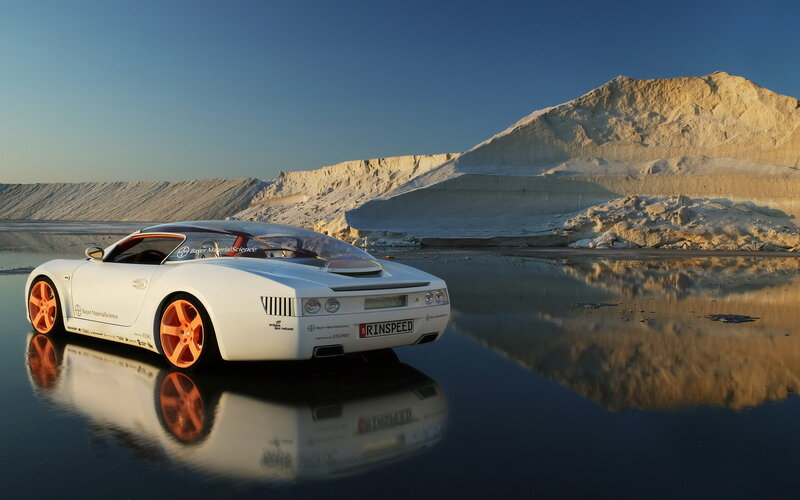 White sports car on reflective water
