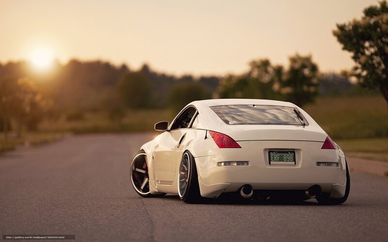 White Sports Car on Road — Serene, Sunset, Photograph