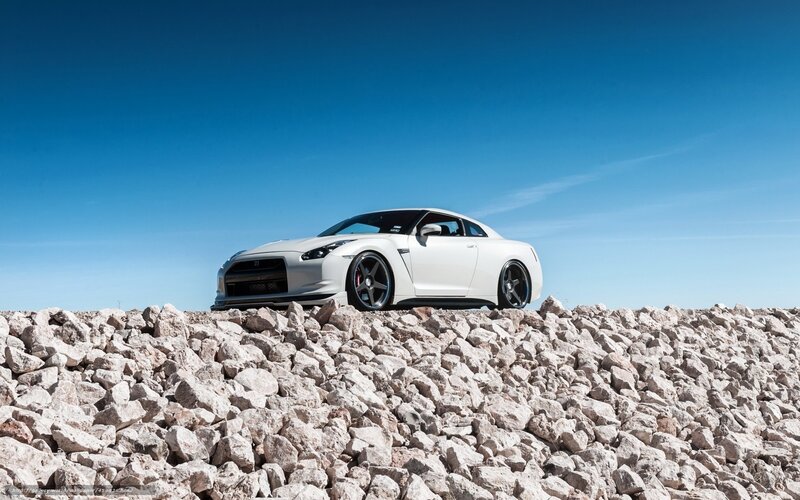White sports car on rocky terrain