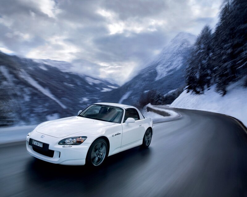White sports car on snowy mountain road