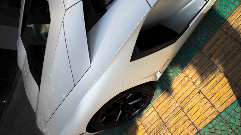 White sports car on tiled pavement