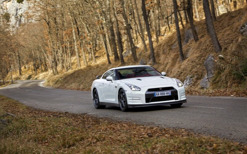 White sports car on winding road
