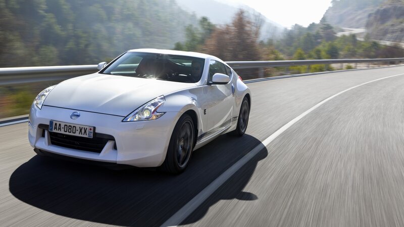white sports car on winding road