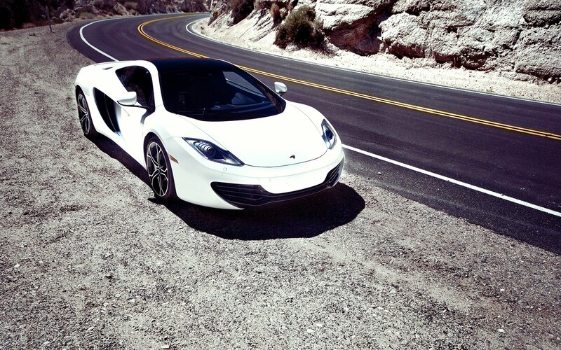 White sports car on winding road